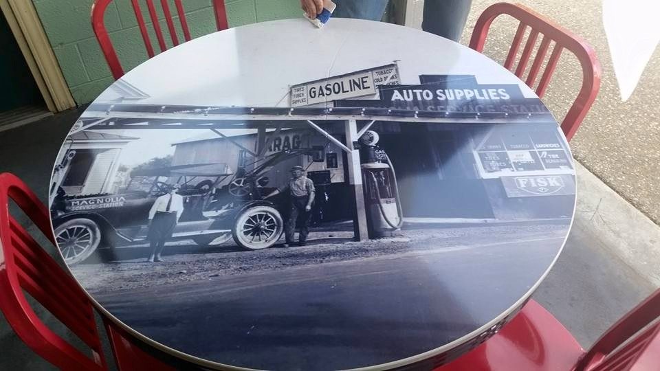 Cafe table inside Tony's printed with a vintage photo of a gas station